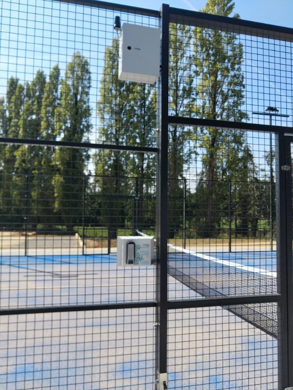 Reader plate and exit button on an outdoor padel court