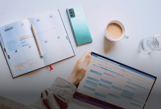 Agenda papier, smartphone et tablette affichant un planning sur un bureau